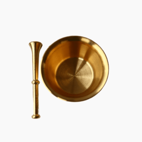 Brass mortar with pestle seen from above