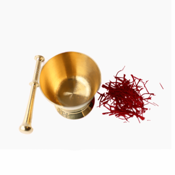 Brass pestle grinding saffron threads